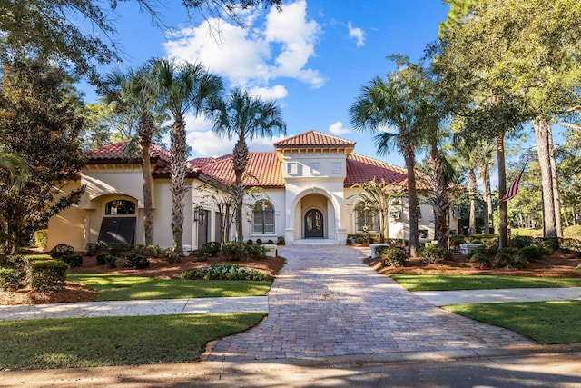 3400 Ravenwood Ln, Miramar Beach, FL 32550 - mediterranean / spanish house featuring stucco siding, a tiled roof, and a front lawn
