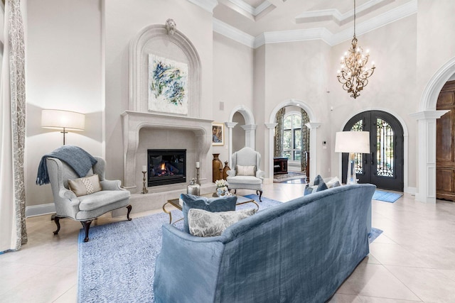 living room featuring french doors, a towering ceiling, light tile patterned flooring, and ornamental molding