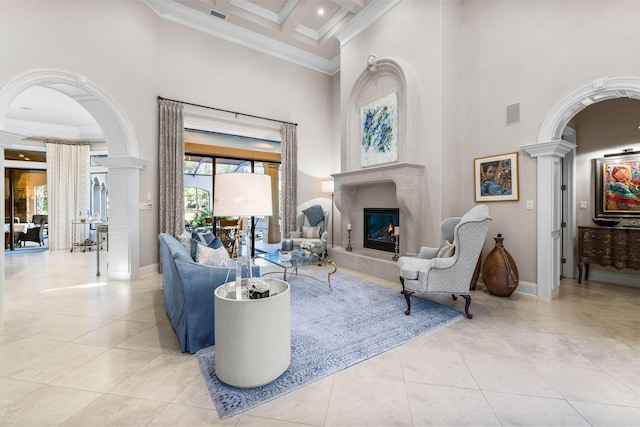 tiled living room featuring a towering ceiling, ornate columns, ornamental molding, coffered ceiling, and beamed ceiling