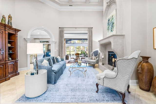 living room with a high ceiling, crown molding, and light tile patterned flooring