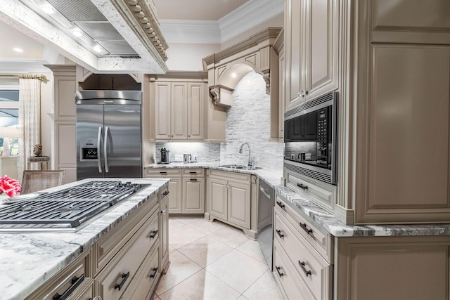 kitchen featuring sink, built in appliances, light stone countertops, light tile patterned floors, and tasteful backsplash