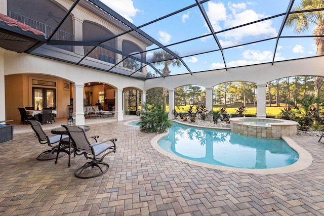 3400 Ravenwood Ln, Miramar Beach, FL 32550 - view of swimming pool with a patio, glass enclosure, and a pool with connected hot tub