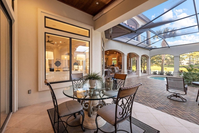 view of patio featuring glass enclosure