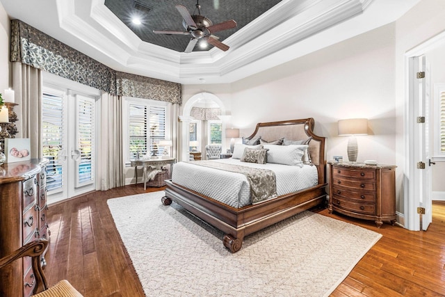 3400 Ravenwood Ln, Miramar Beach, FL 32550 - bedroom with crown molding, access to exterior, a tray ceiling, hardwood / wood-style flooring, and ceiling fan
