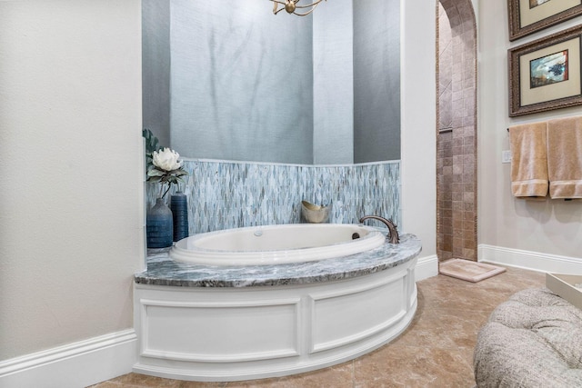 bathroom featuring tile patterned floors and a washtub