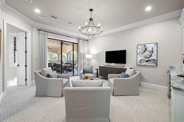 carpeted living room featuring crown molding and a chandelier