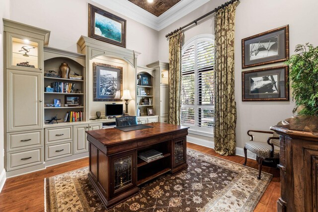 office space with dark hardwood / wood-style floors and crown molding