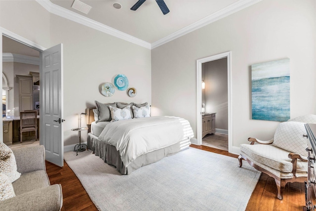 bedroom with ensuite bathroom, ceiling fan, crown molding, and dark wood-type flooring