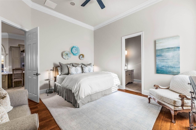 3400 Ravenwood Ln, Miramar Beach, FL 32550 - bedroom with crown molding, baseboards, dark wood-style floors, ensuite bath, and ceiling fan