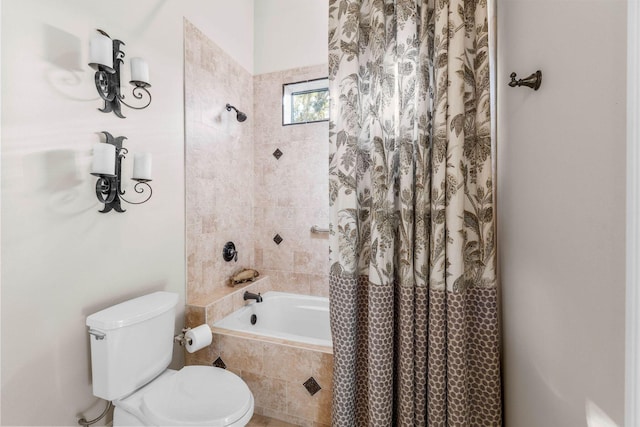 bathroom with shower / tub combo and toilet