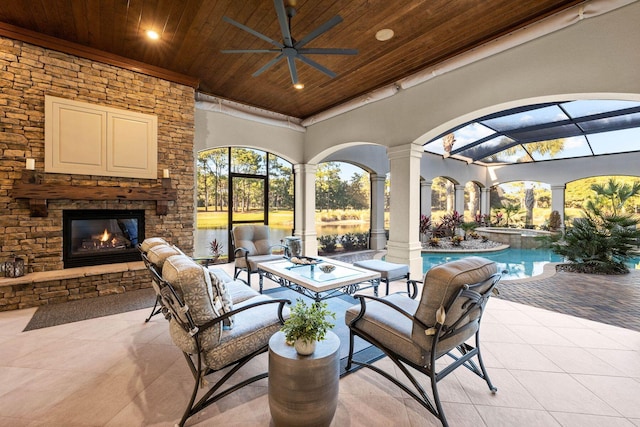 view of patio featuring an outdoor stone fireplace and ceiling fan