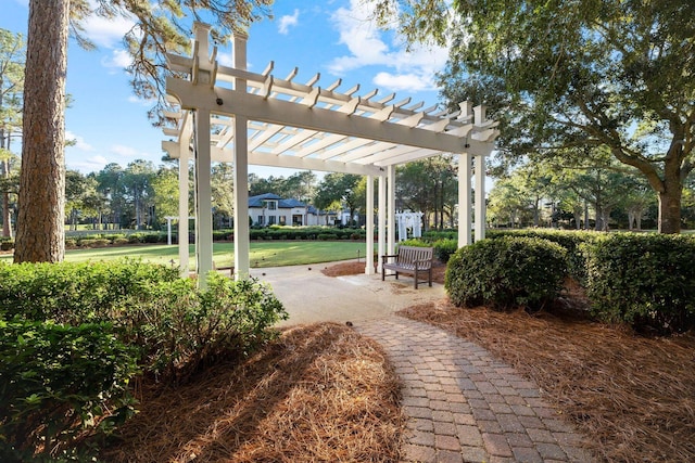 view of community featuring a lawn and a pergola