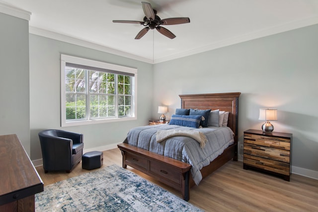 bedroom with ceiling fan, light wood-type flooring, and crown molding