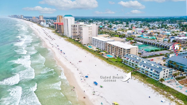 bird's eye view with a water view and a beach view