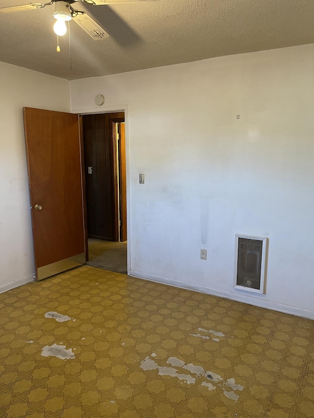 spare room with ceiling fan and a textured ceiling