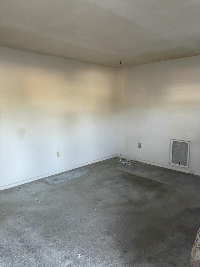 carpeted empty room with a textured ceiling