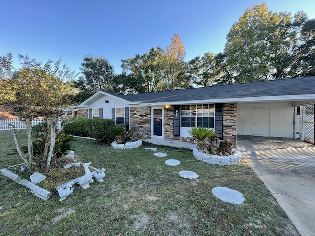 ranch-style home featuring a carport and a front lawn