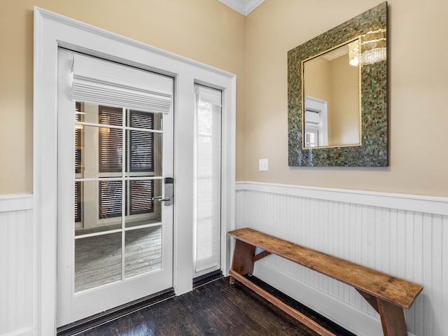 entryway with dark hardwood / wood-style floors and crown molding