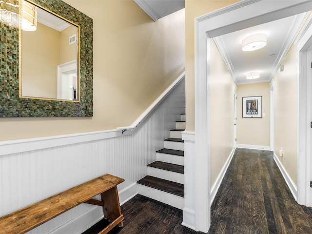 stairway with crown molding and wood-type flooring