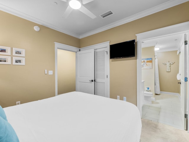 bedroom featuring a closet, ceiling fan, crown molding, and light colored carpet