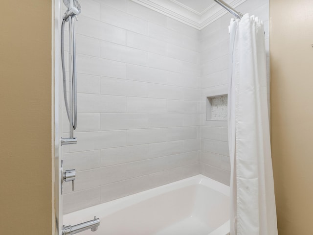 bathroom with shower / bath combo with shower curtain and ornamental molding