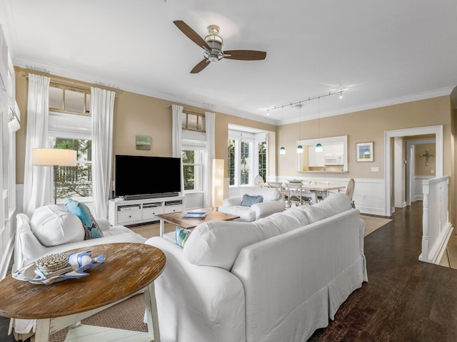 living room with dark hardwood / wood-style flooring, rail lighting, ceiling fan, and ornamental molding