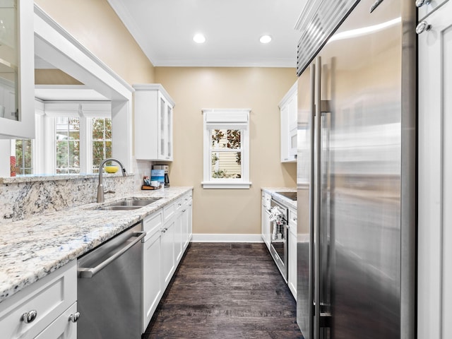 kitchen with stainless steel appliances, crown molding, dark wood-type flooring, sink, and white cabinets