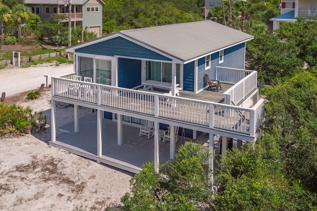 back of property with a patio area and a wooden deck