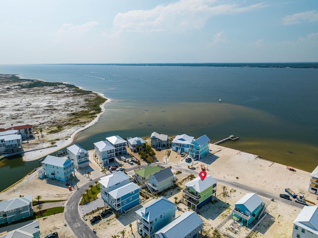 birds eye view of property featuring a beach view and a water view