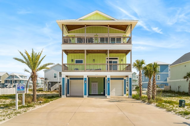 coastal inspired home with a garage and a balcony