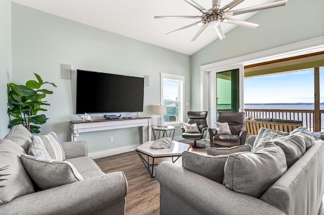 living room with ceiling fan, lofted ceiling, and hardwood / wood-style flooring