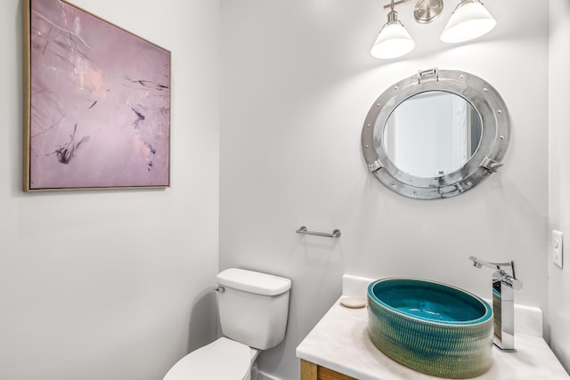 bathroom with toilet and vanity