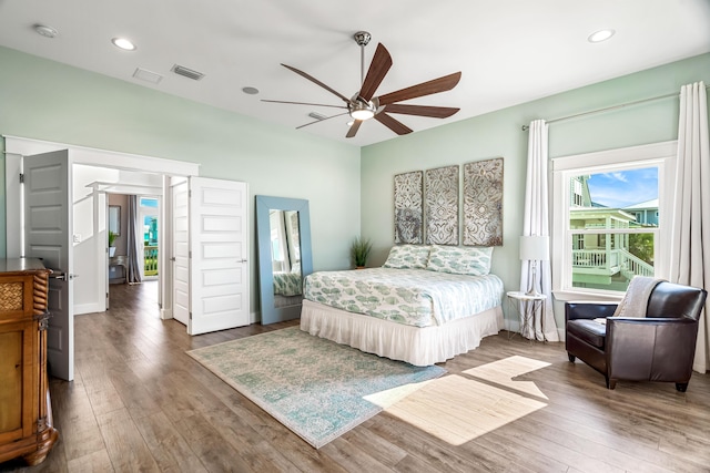 bedroom with ceiling fan and dark hardwood / wood-style flooring