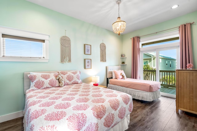 bedroom with access to exterior, dark hardwood / wood-style floors, and a notable chandelier