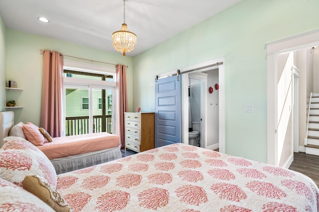 bedroom with a chandelier, a barn door, wood-type flooring, and access to outside