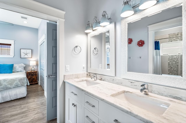 bathroom with curtained shower, wood-type flooring, and vanity