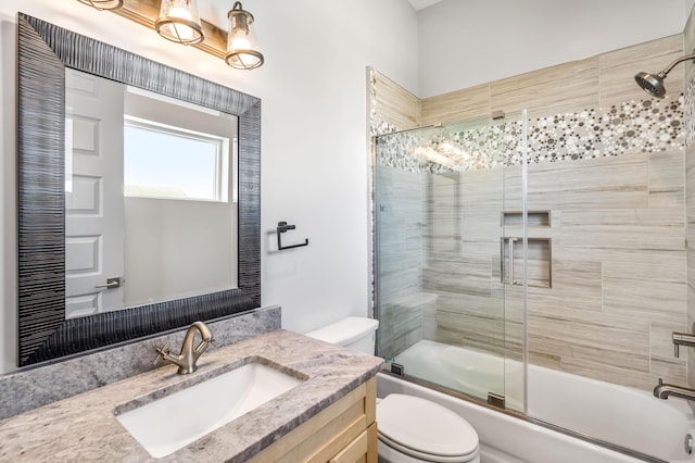 full bathroom with enclosed tub / shower combo, toilet, and vanity