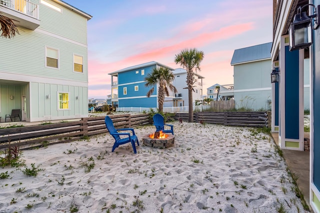 yard at dusk with an outdoor fire pit