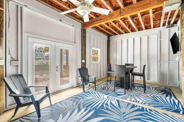 sunroom / solarium featuring ceiling fan and french doors