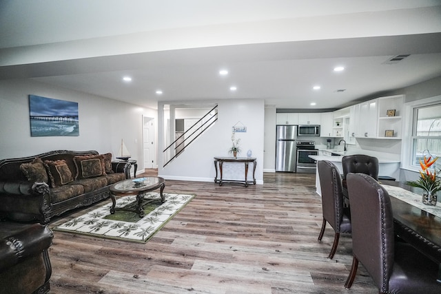 living room featuring light hardwood / wood-style flooring and sink