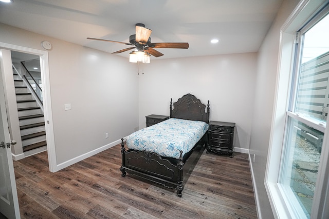 bedroom with dark hardwood / wood-style floors and ceiling fan