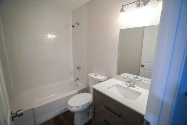 full bathroom featuring hardwood / wood-style floors, vanity, toilet, and tiled shower / bath