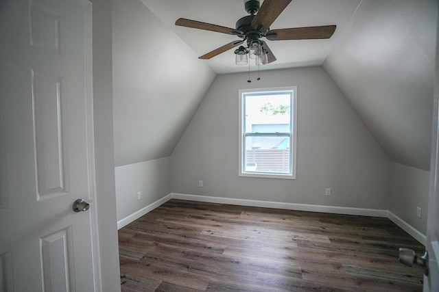 bonus room with ceiling fan, dark wood-type flooring, and vaulted ceiling