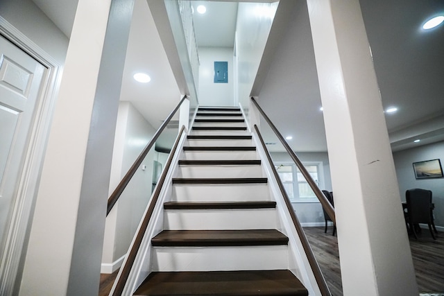 staircase featuring wood-type flooring