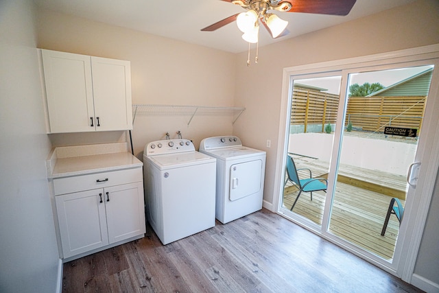 washroom featuring cabinets, light hardwood / wood-style flooring, ceiling fan, and washer and dryer