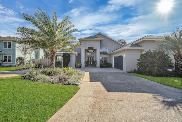 view of front of home with a front yard and a garage