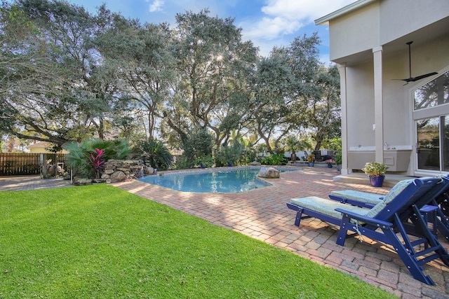 view of pool with a lawn, ceiling fan, and a patio