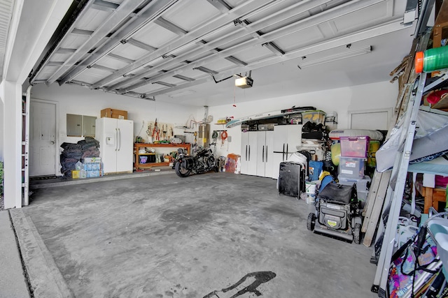 garage with white fridge with ice dispenser and a garage door opener