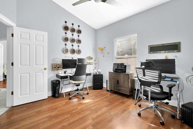 office space featuring ceiling fan, light hardwood / wood-style floors, and vaulted ceiling