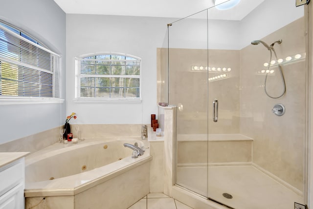 bathroom featuring tile patterned flooring, vanity, and shower with separate bathtub